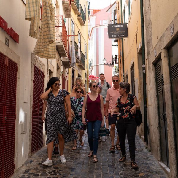 a group of people walking on a sidewalk