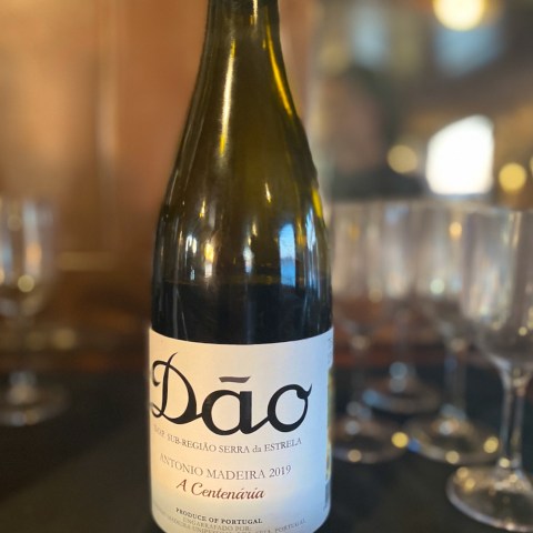 a close up of a bottle and a glass of wine