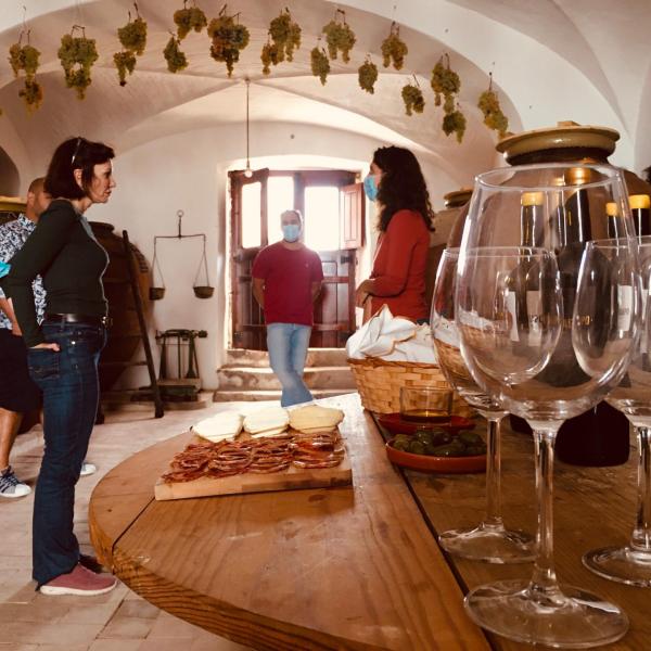 a person sitting at a table with wine glasses