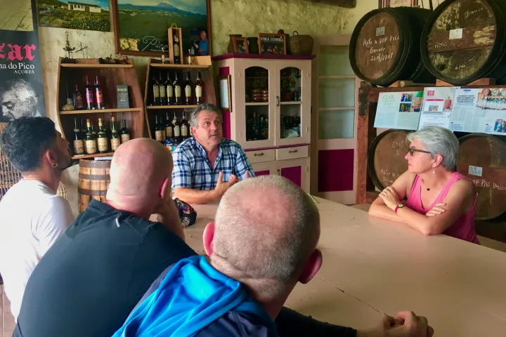 a group of people looking at a cell phone