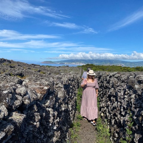 a group of people standing on a rocky hill