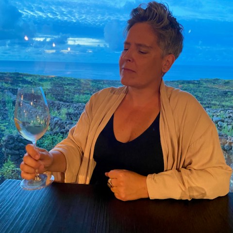 a man and woman sitting next to a body of water