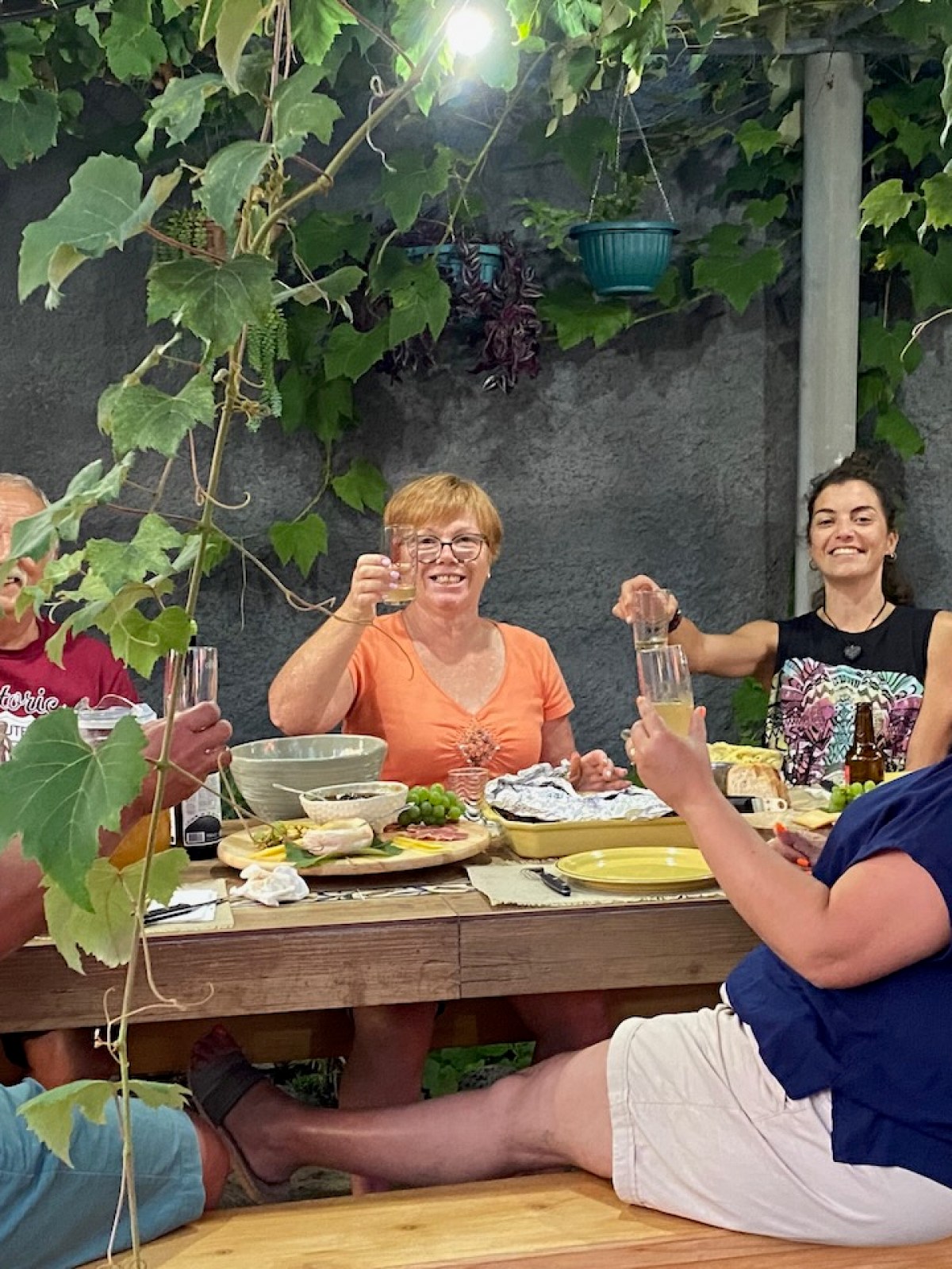 a group of people sitting at a table eating food