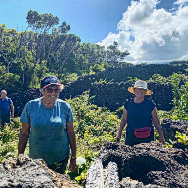 a group of people standing on a rock