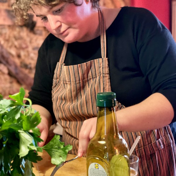 a woman sitting at a table with a glass of wine