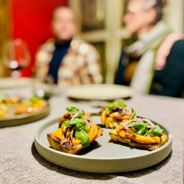 a group of people sitting at a table with a plate of food