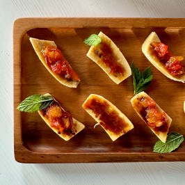 a bunch of food sitting on top of a wooden cutting board