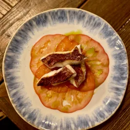 a plate of food sitting on top of a wooden table