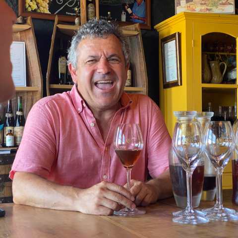 a person sitting at a table with wine glasses