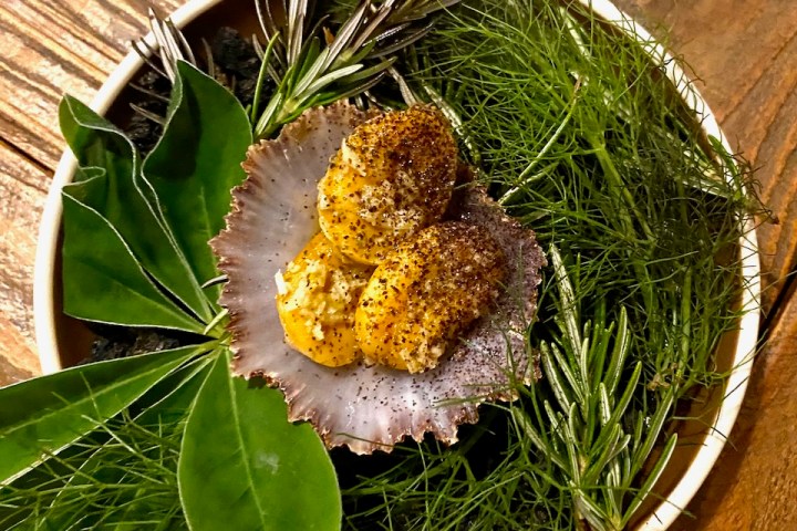 a plate of food sitting on top of a wooden table