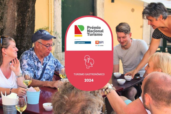 a group of people standing around a table