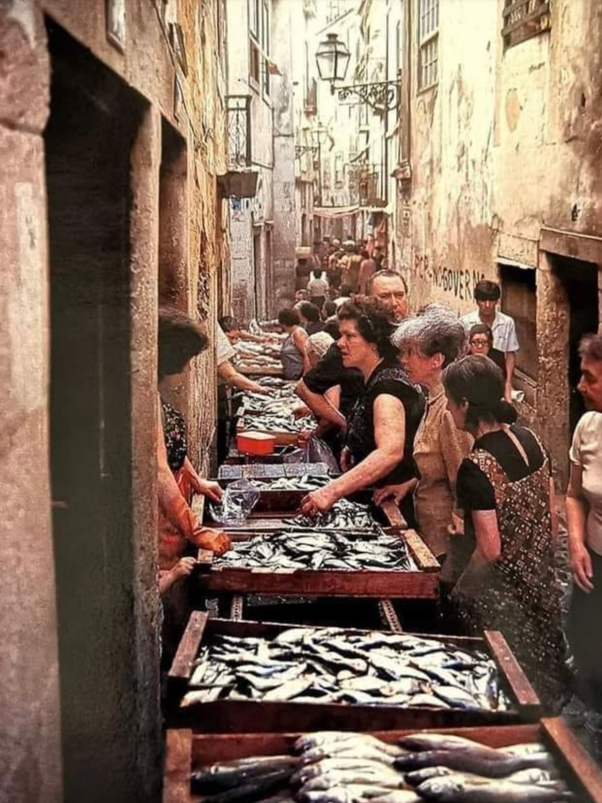 a group of people sitting in front of a building