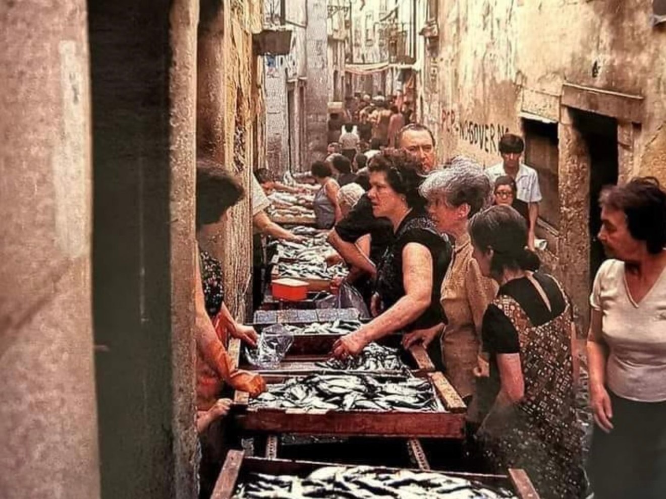 a group of people sitting in front of a building
