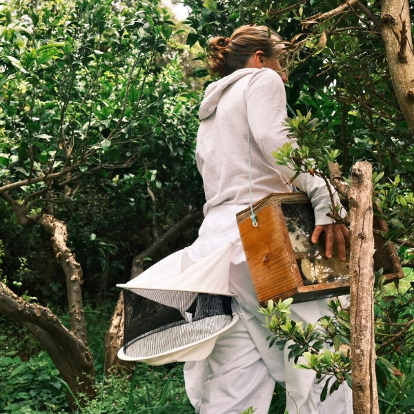a man standing next to a tree