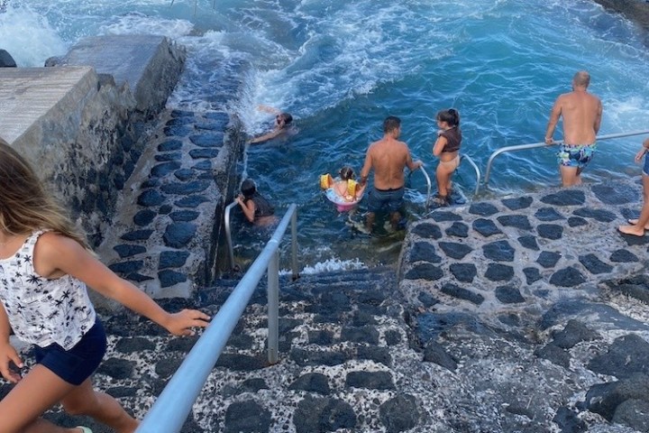 a group of people on a rocky beach