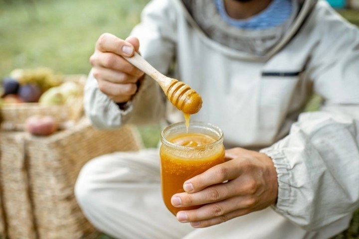 a person holding a glass of orange juice