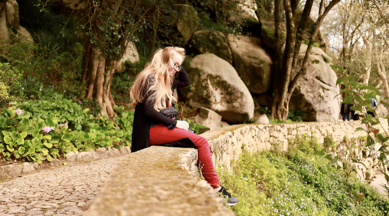 a person sitting on a rock