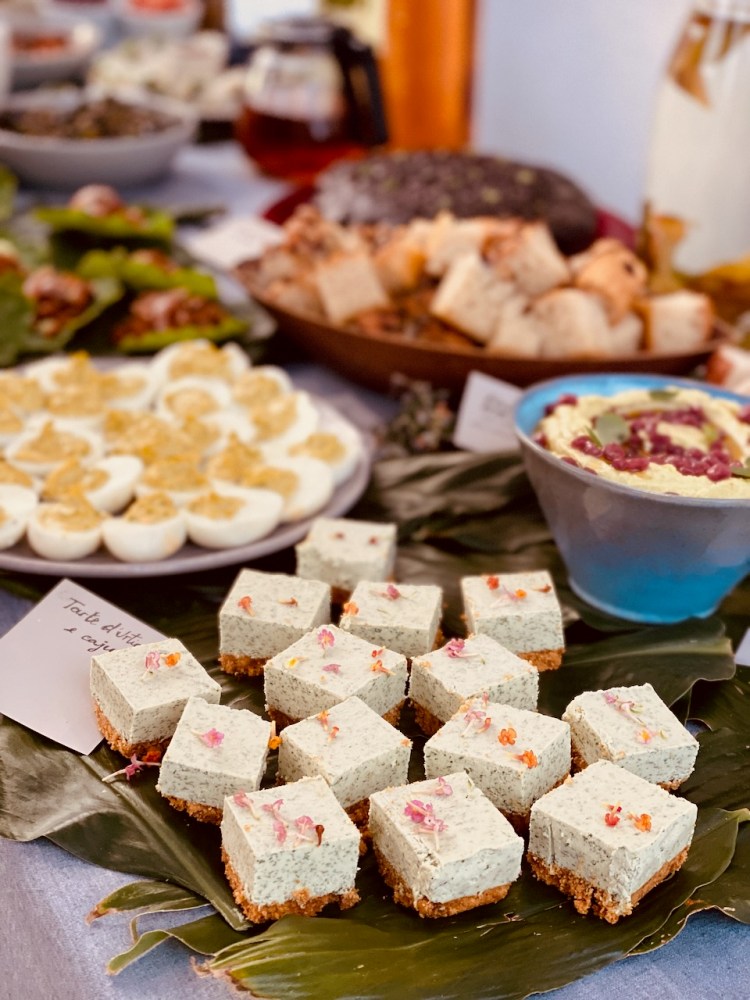 Buffet table with desserts, deviled eggs, bread, and dip on display.
